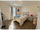 Bright bedroom featuring decorative headboard, stylish light fixture, and wood-look flooring at 160 Leadwood St., Andrews, SC 29510