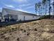 Exterior view of the home showcasing the covered patio and spacious yard at 160 Leadwood St., Andrews, SC 29510