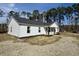 Beautiful exterior of the home with a covered porch and large yard surrounded by trees at 160 Leadwood St., Andrews, SC 29510