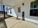 Charming front porch with a welcome mat and sign, complemented by sleek white vinyl siding at 160 Leadwood St., Andrews, SC 29510