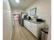 Bright hallway with granite countertop and modern stainless steel fridge with wood-look flooring at 160 Leadwood St., Andrews, SC 29510
