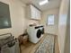 Functional laundry room with a washer, dryer, storage cabinets, and wood-look flooring at 160 Leadwood St., Andrews, SC 29510