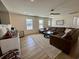 Spacious living room featuring a comfortable couch, ceiling fan and large windows at 160 Leadwood St., Andrews, SC 29510