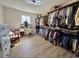 Spacious walk-in closet with built-in shelving, ample storage, vanity, and wood-look flooring at 160 Leadwood St., Andrews, SC 29510