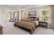 Tranquil bedroom with comfortable bed, side tables, soft lighting, and lots of natural light at 1800 Hardwood Ct., Conway, SC 29526