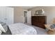 Bedroom with a bed and an open door leading into a bathroom, accented by a wooden dresser and decorative mirror at 1800 Hardwood Ct., Conway, SC 29526