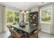 Bright dining room features stylish wicker chairs, contemporary chandelier and sliding door to outdoor living at 1800 Hardwood Ct., Conway, SC 29526