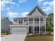 Charming two-story home featuring a welcoming front porch and attached two-car garage at 1800 Hardwood Ct., Conway, SC 29526