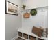 Functional entryway featuring hooks, storage baskets, a bench with pillows and a ship artwork, offering a welcoming space at 1808 Hardwood Ct., Conway, SC 29526