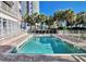 Beautiful outdoor pool surrounded by palm trees and lounge chairs for relaxing by the water on a sunny day at 2106 N Ocean Blvd. # 712, Myrtle Beach, SC 29577