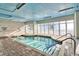Indoor pool with brick flooring and stairs leading into crystal-clear water, ideal for year-round enjoyment at 2106 N Ocean Blvd. # 712, Myrtle Beach, SC 29577