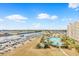 Elevated view of waterway, marina, pool and condominium complex set against a blue sky at 2151 Bridge View Ct. # 1003, North Myrtle Beach, SC 29582