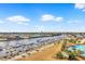 Expansive aerial view of the waterway, marina, pool area, and complex against a blue sky at 2151 Bridge View Ct. # 11003, North Myrtle Beach, SC 29582