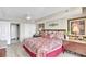Bright bedroom features bed, dressers, red accents and closet with mirrored doors at 2151 Bridge View Ct. # 11003, North Myrtle Beach, SC 29582