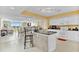 Bright kitchen area featuring an island with bar stools, flowing seamlessly into the dining and living areas at 2151 Bridge View Ct. # 11003, North Myrtle Beach, SC 29582