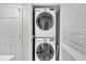 Efficient laundry room with stacked washer and dryer and a nearby storage closet at 2151 Bridge View Ct. # 11003, North Myrtle Beach, SC 29582