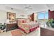 Bright bedroom features bed, dressers, red accents and balcony with a view at 2151 Bridge View Ct. # 11003, North Myrtle Beach, SC 29582