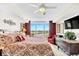 Bright bedroom features bed, dressers, red accents and balcony with a view at 2151 Bridge View Ct. # 11003, North Myrtle Beach, SC 29582