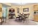 A dining area adjacent to the kitchen, featuring a round table and ornate chairs under a chandelier at 2276 Essex Dr. # H, Surfside Beach, SC 29575