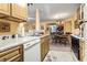 Bright kitchen with wooden cabinets and breakfast bar overlooks dining area at 2276 Essex Dr. # H, Surfside Beach, SC 29575