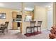 An efficient kitchen with oak cabinets, white appliances, and a bar area connecting it to the living space at 2276 Essex Dr. # H, Surfside Beach, SC 29575