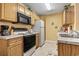 Functional kitchen features wooden cabinets, modern appliances, and tile flooring at 2276 Essex Dr. # H, Surfside Beach, SC 29575