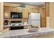 Well-equipped kitchen features a breakfast bar with modern appliances and wooden cabinetry at 2276 Essex Dr. # H, Surfside Beach, SC 29575