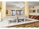 View of the double kitchen sink with eat-in bar overlooking the living area at 2276 Essex Dr. # H, Surfside Beach, SC 29575