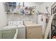 Functional laundry room with washer, dryer, shelves, and water heater for efficient home maintenance at 2276 Essex Dr. # H, Surfside Beach, SC 29575
