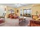 A living room with neutral walls and carpet, featuring an ornate seating area and decorative accessories at 2276 Essex Dr. # H, Surfside Beach, SC 29575