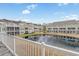 View of the backyard features a picturesque pond and well-maintained condo complex at 2557 Pete Dye Dr. # 402, North Myrtle Beach, SC 29582