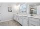 Bright bathroom featuring double vanity, white cabinets and framed mirrors at 2557 Pete Dye Dr. # 402, North Myrtle Beach, SC 29582