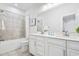 Bright bathroom features double vanity, tiled shower/tub and modern fixtures at 2557 Pete Dye Dr. # 402, North Myrtle Beach, SC 29582