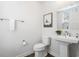 Well-lit half bathroom with a pedestal sink and framed artwork for added character at 2557 Pete Dye Dr. # 402, North Myrtle Beach, SC 29582