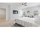Light-filled main bedroom with ceiling fan, large windows, and en-suite bathroom at 2557 Pete Dye Dr. # 402, North Myrtle Beach, SC 29582