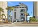 Beach Cabana building at Barefoot Resort and Golf with palm trees and beach access at 2557 Pete Dye Dr. # 402, North Myrtle Beach, SC 29582