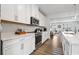 Bright, modern kitchen features white cabinets, stainless appliances, and hardwood floors at 2557 Pete Dye Dr. # 402, North Myrtle Beach, SC 29582