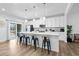 Well-lit kitchen with a large island, bar seating, stainless appliances, and sleek white cabinets at 2557 Pete Dye Dr. # 402, North Myrtle Beach, SC 29582