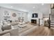 Bright living room with large sectional sofa, modern decor, and staircase access at 2557 Pete Dye Dr. # 402, North Myrtle Beach, SC 29582