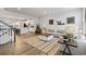 Bright living room with wood floors, neutral tones, decorative rug, and eye-catching art at 2557 Pete Dye Dr. # 402, North Myrtle Beach, SC 29582