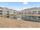 Community pond with fountain and a view of the back of the townhomes at 2557 Pete Dye Dr. # 402, North Myrtle Beach, SC 29582