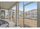 Screened porch has seating area and community views of the lake and fountain at 2557 Pete Dye Dr. # 402, North Myrtle Beach, SC 29582
