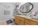 Full bathroom with wooden cabinets, granite countertop, large mirror and tile flooring at 2601 Rosehip Ct., Conway, SC 29527