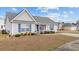 Inviting single-level home with blue shutters and a welcoming front porch at 2601 Rosehip Ct., Conway, SC 29527