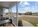 Inviting front porch view of a home with a table and chairs, perfect for relaxing and enjoying the neighborhood scenery at 2601 Rosehip Ct., Conway, SC 29527