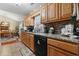 Kitchen features wood cabinetry, granite countertops, tile backsplash, and a view into the dining area at 2601 Rosehip Ct., Conway, SC 29527