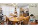 Eat-in kitchen boasts hardwood floors, light-filled windows, a dining table and an adjacent kitchen at 2601 Rosehip Ct., Conway, SC 29527