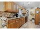 Kitchen area boasts wood cabinets, tile flooring, granite counters and view to eat in kitchen at 2601 Rosehip Ct., Conway, SC 29527