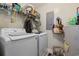Functional laundry room featuring a white washer and dryer, storage shelves and utilitarian water heater at 2601 Rosehip Ct., Conway, SC 29527