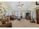Spacious living room featuring a vaulted ceiling, comfortable seating, and a large TV, perfect for entertainment and relaxation at 2601 Rosehip Ct., Conway, SC 29527
